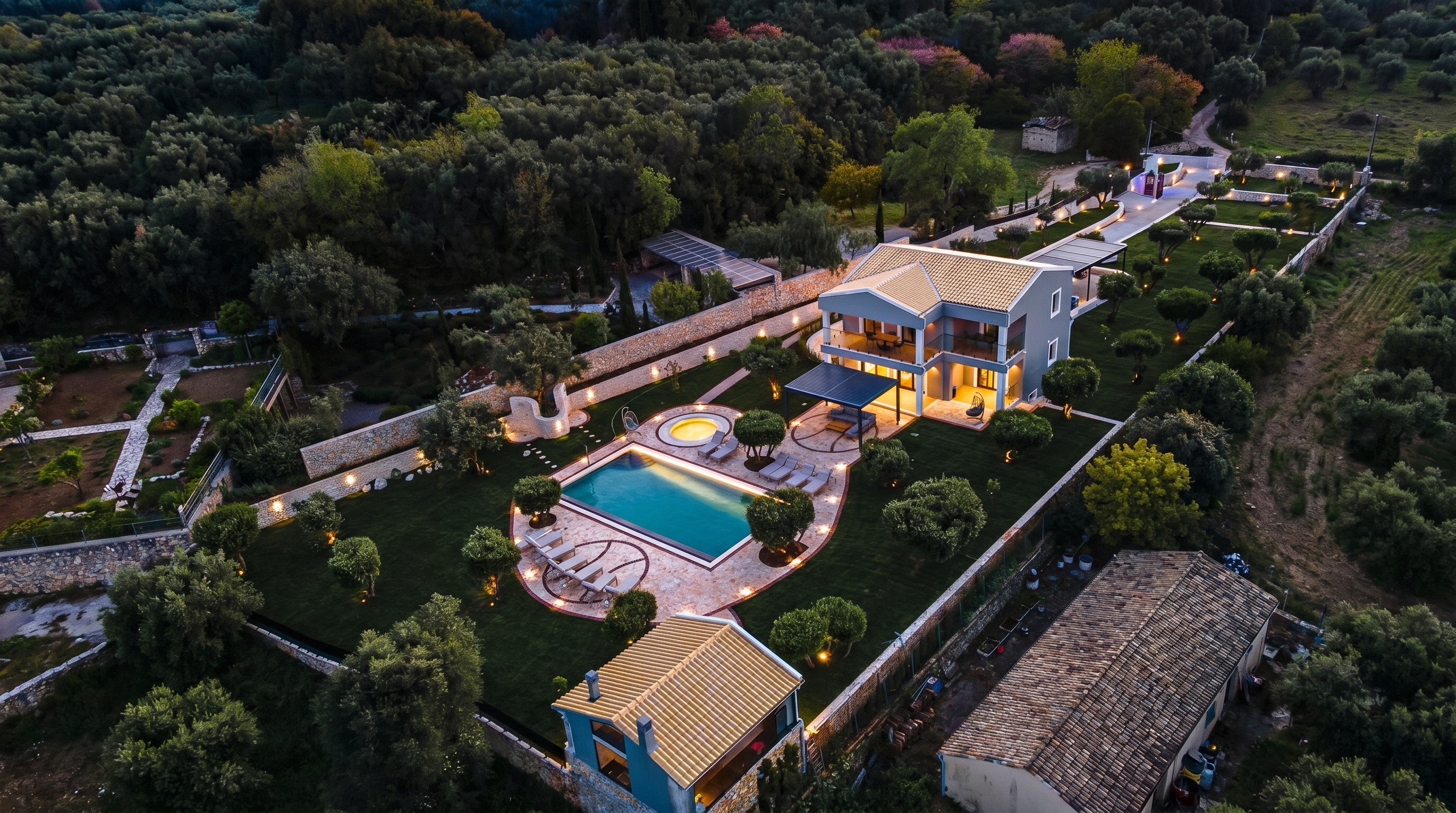 Villa No. 10, An estate wrapped in stone: cobbled drive, serpentine walls and flagstone pool terraces.