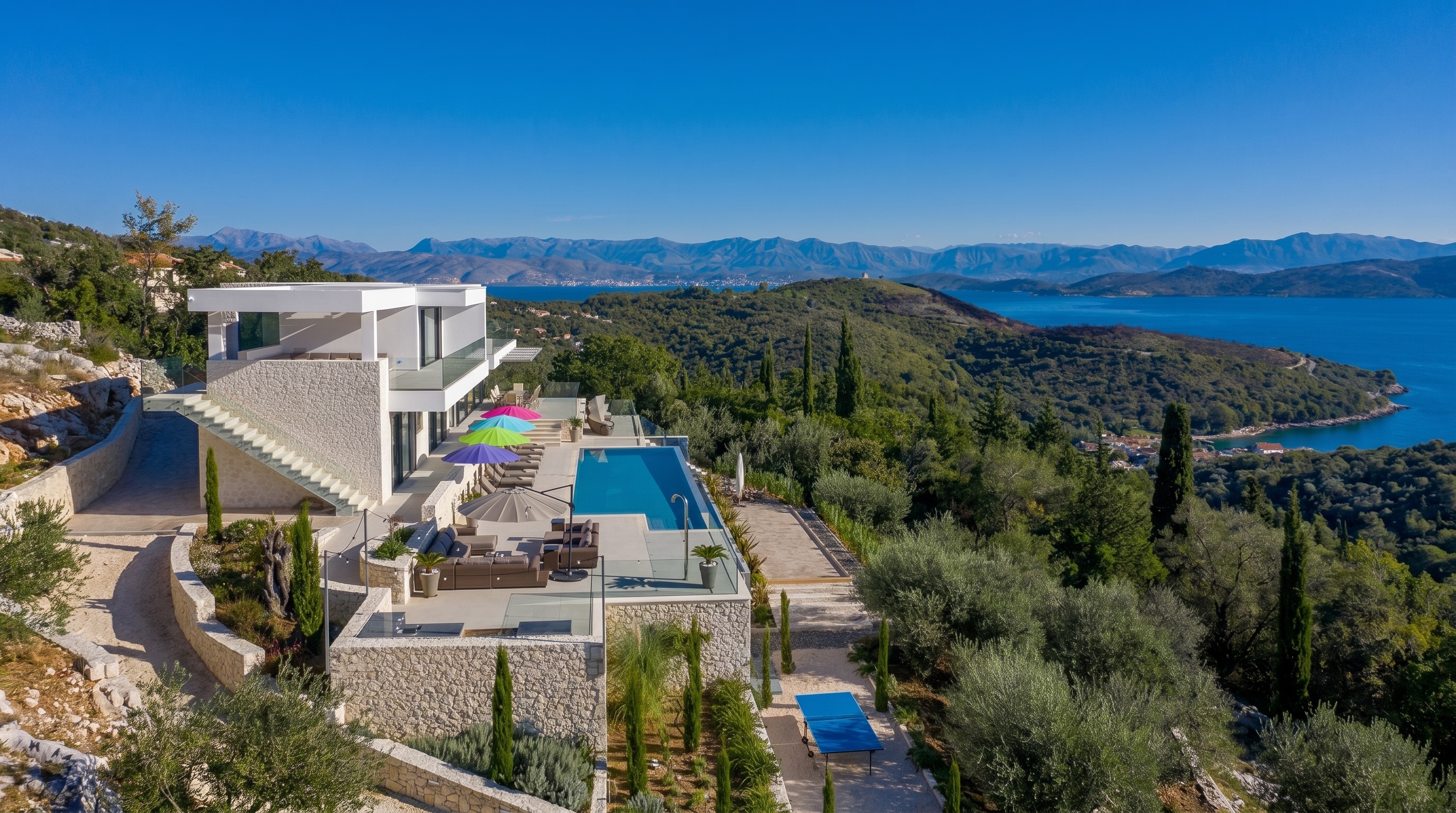 Villa No. 2, A contemporary hillside villa where one stone carries the house, the walls and the drive.