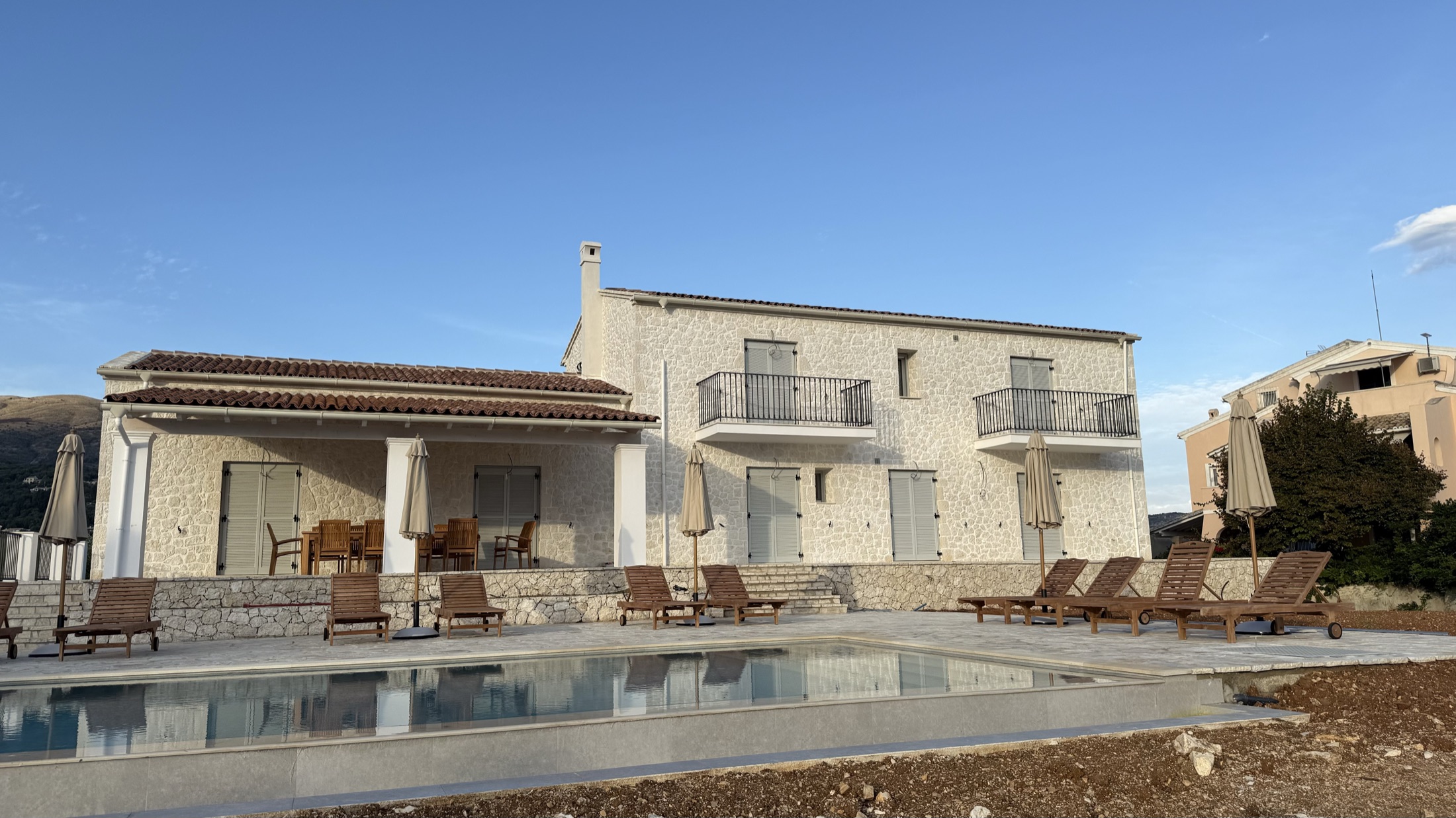 Villa No. 3, A hilltop villa clad in pale limestone, from basement wall to oculus.