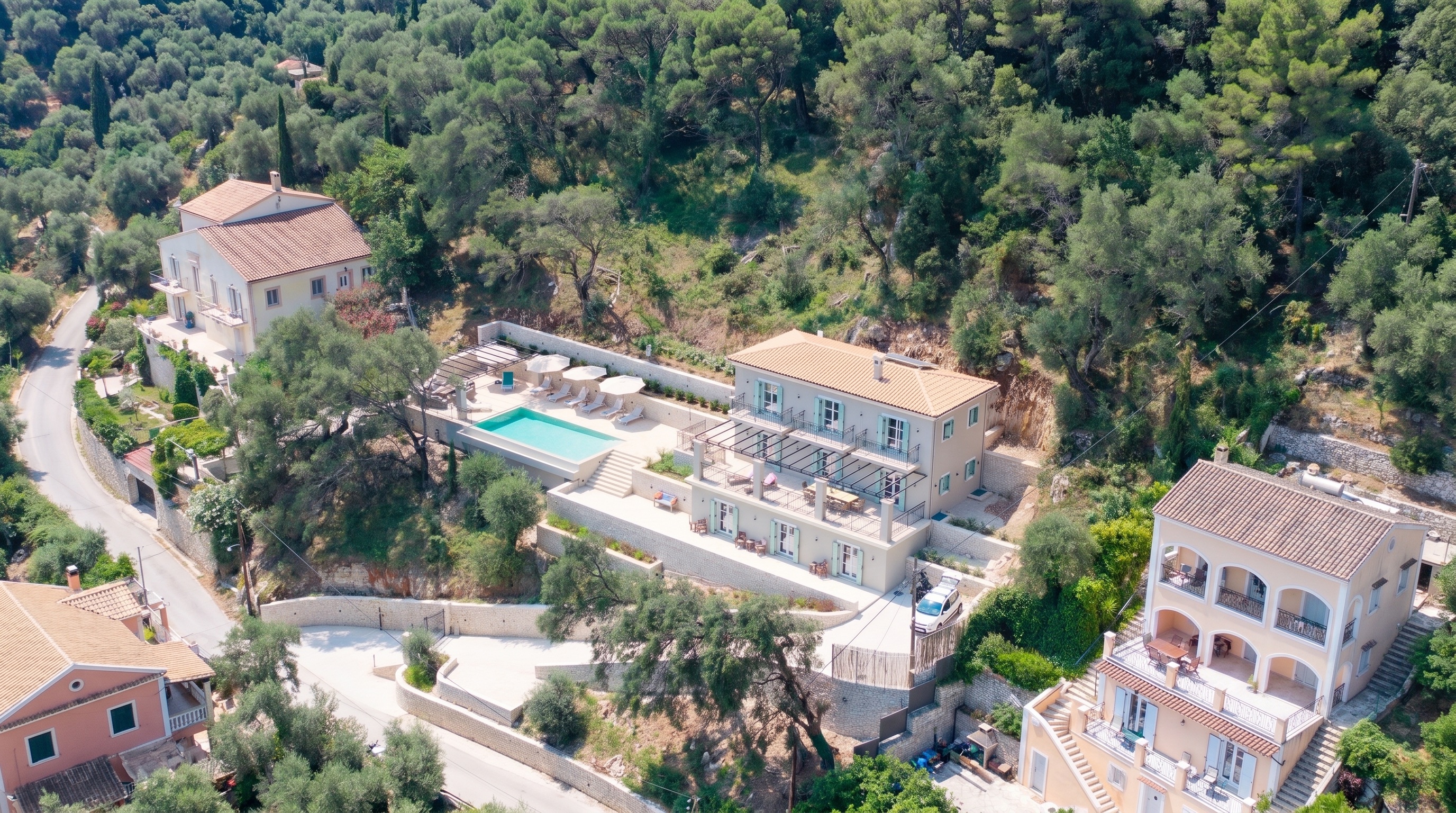 Villa No. 9, Serpentine tiered walls terracing an olive hillside, built around the trees.